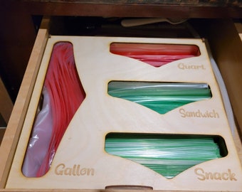 Storage bag organizer for mounting on wall or putting in a drawer.