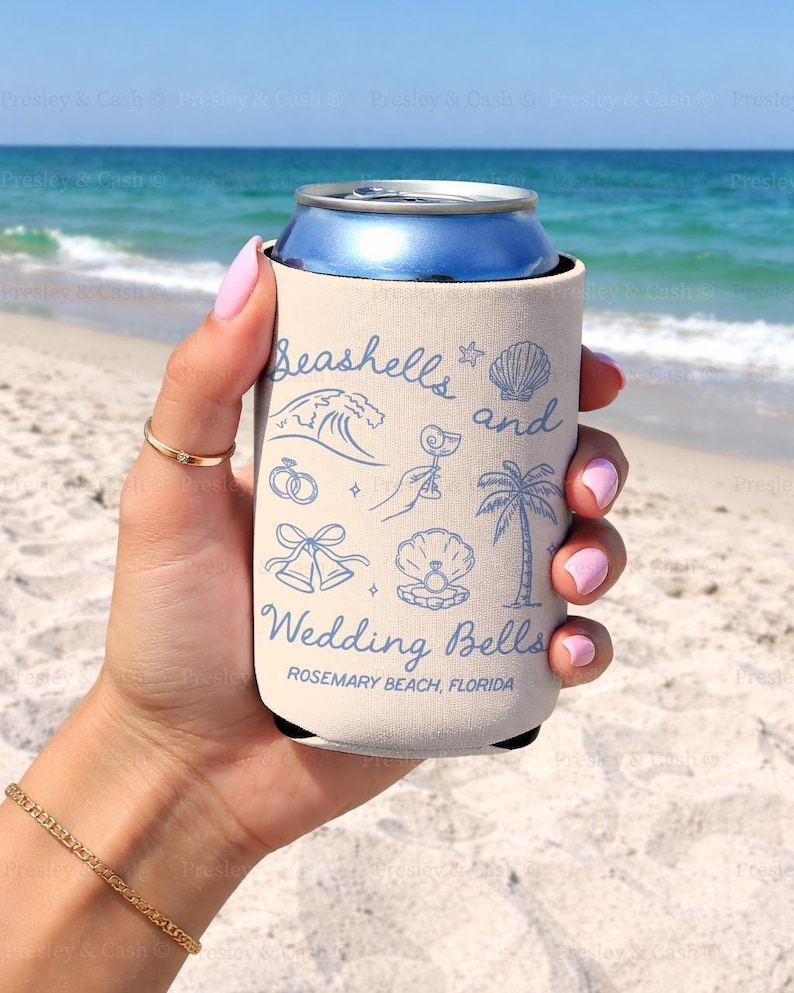 Cream can cooler held at the beach with “Seashells and Wedding Bells” printed in blue. Beachy bridal theme includes a shell, wave, palm tree, and rings. Customized with Rosemary Beach, Florida.