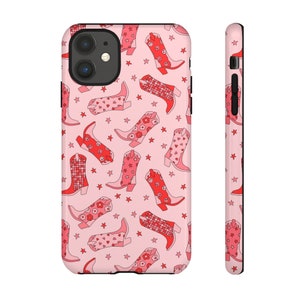 May include: Pink phone case with a pattern of red cowboy boots and white stars.