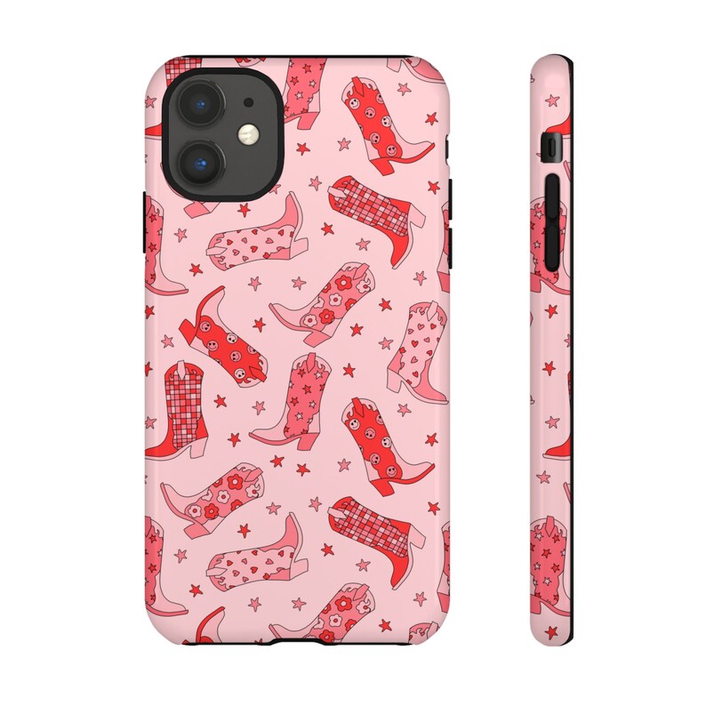 May include: Pink phone case with a pattern of red cowboy boots and white stars.