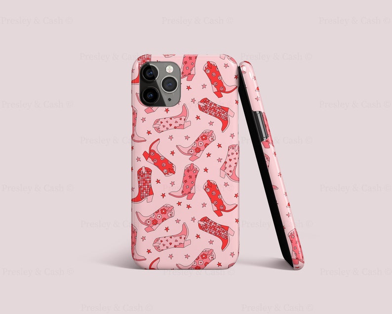 May include: Pink iPhone case with a pattern of red cowboy boots with floral designs. The case is shown from the side and the back.