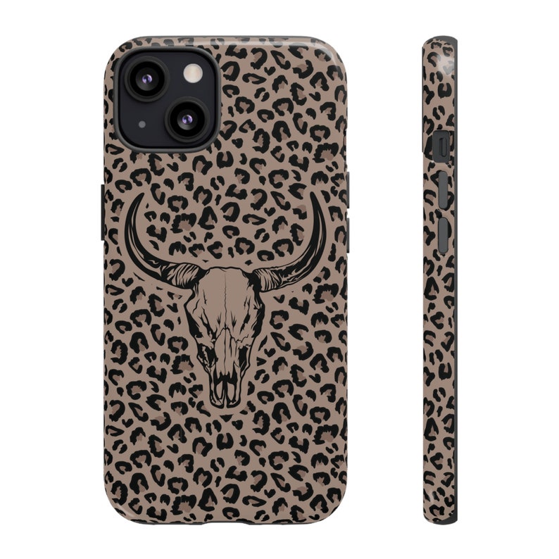 May include: A brown and black leopard print phone case with a black silhouette of a bull skull in the center.