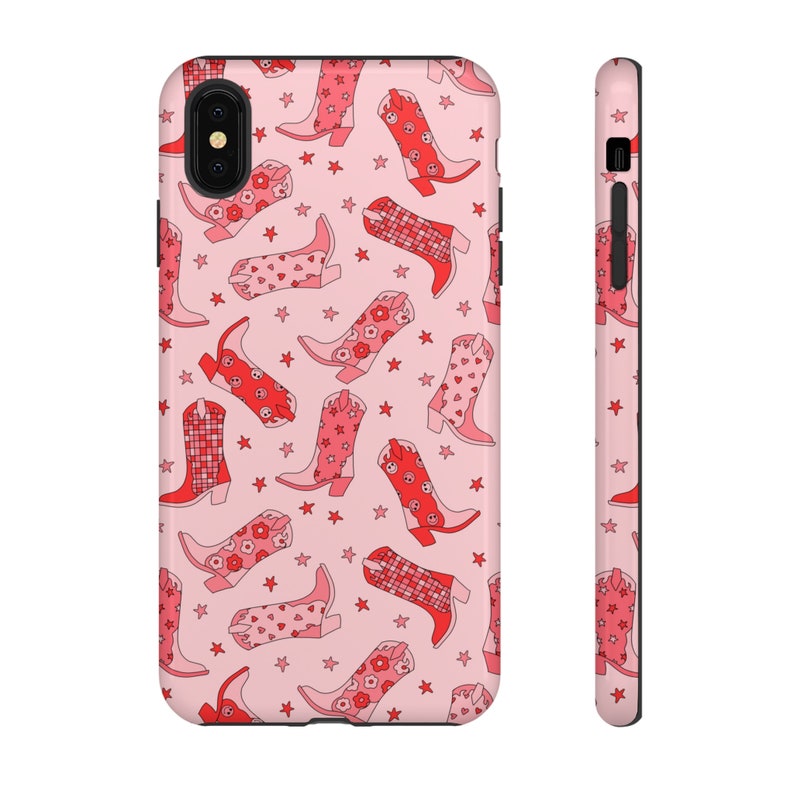 May include: Pink phone case with a pattern of red cowboy boots with floral designs. The case has a black border and a camera cutout.