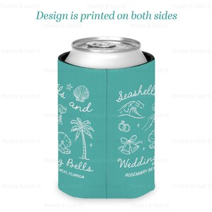 Teal can cooler with “Seashells and Wedding Bells” design printed on both sides, featuring beachy icons like waves, palm trees, rings, and wedding bells. Rosemary Beach bachelorette theme.