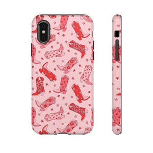 May include: A pink phone case with a pattern of red cowboy boots and stars.
