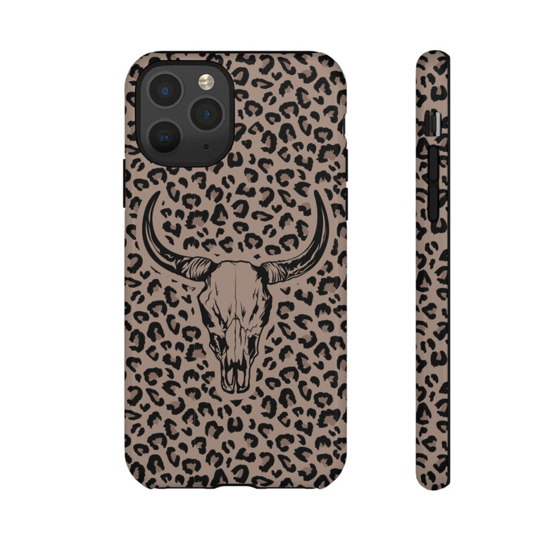 May include: A black and brown leopard print phone case with a black and white bull skull graphic.