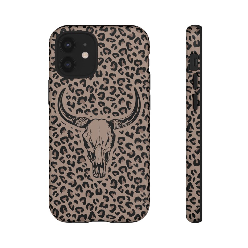 May include: A black phone case with a brown and black leopard print and a black bull skull graphic.