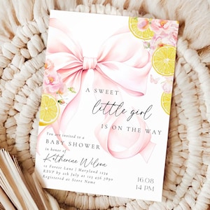 May include: Baby shower invitation with a pink bow, lemons, and floral accents. The text reads "A sweet little girl is on the way." Includes details for Katherine Wilson's baby shower, date, and time.