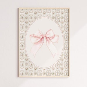 May include: A framed print with a pink bow on a white background. The frame has a decorative border with a floral pattern.