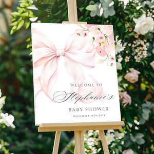 Plantilla de letrero de bienvenida para baby shower con lazo rosa y flores, elegante letrero de acuarela con lazo floral para niña, letrero imprimible para baby shower en Canva