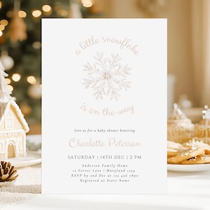 May include: Baby shower invitation with the text "a little snowflake is on the way." The invitation features a snowflake design and includes the name "Charlotte Peterson" and event details.