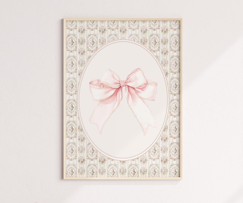 May include: A framed print with a pink bow on a white background. The frame has a decorative border with a floral pattern.