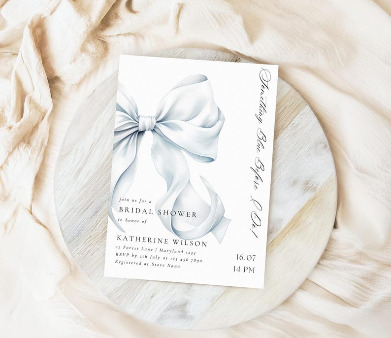 May include: A white bridal shower invitation with a watercolor illustration of a large white bow. The text reads "Something Blue Before Do!" and includes the bride's name, date, time, and RSVP information.