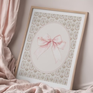 May include: A framed print with a pink bow on a light pink background with a floral pattern. The bow is tied with a large, soft loop and has a delicate, shimmery texture.
