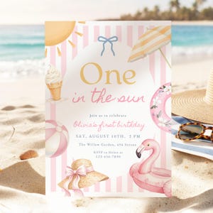 May include: A birthday invitation card with a pink and white striped background featuring illustrations of a sun, ice cream cone, beach umbrella, floral swim ring, sun hat, and flamingo float. Text reads: One in the sun, Olivia's first birthday.