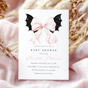 May include: Baby shower invitation with a pink bow and black bat wings design. The invitation includes the text "please join us for a BABY SHOWER honoring Elisabeth Peterson".