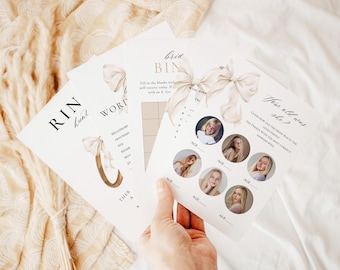 May include: A hand holds several white bridal shower game cards. The cards feature text like "Ring Hunt" and "How old was she?" with decorative bows. The games include fill-in-the-blank and photo guessing activities.