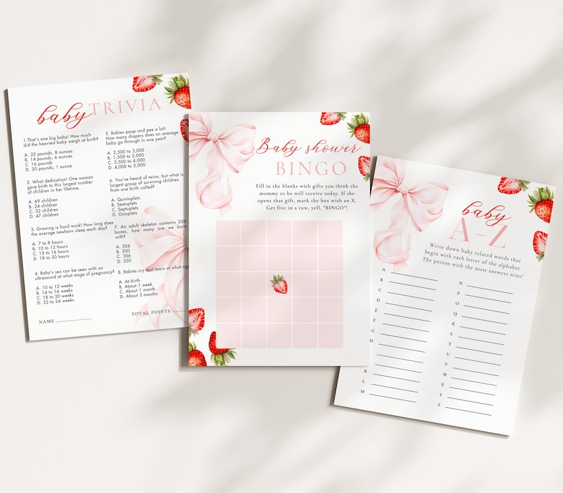 May include: Three baby shower game sheets with strawberry and bow accents. The games include trivia, bingo, and an A-Z game. The text on the sheets includes "baby trivia", "baby shower bingo", and "baby A-Z". The color scheme is primarily pink and white.