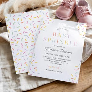 May include: Baby Sprinkle invitation with a confetti design. The invitation includes the text "Baby Sprinkle" and event details. Pink baby shoes are in the background. The invitation is for Katherine Peterson.
