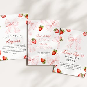 May include: Three white cards with pink bows and strawberries, designed for a baby shower. The cards have text: "Late Night Diapers", "How many bows are in the jar?", and "How big is Mommy's belly?" The cards are decorated with watercolor illustrations.