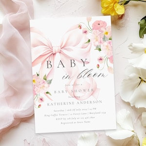 May include: A pink baby shower invitation with a pink bow and floral design. The text reads "Baby in Bloom" and includes the date, time, and location of the shower. RSVP information is also included.