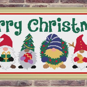 May include: A cross-stitch pattern featuring six gnomes with different Christmas-themed accessories, including a candy cane, a gift box, a Christmas tree, a wreath, a gingerbread cookie, and a reindeer. The gnomes are lined up in a row with the text "Merry Christmas" above them.