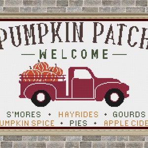 May include: A red vintage truck with a white bed filled with orange pumpkins. The truck is in front of a white sign with the text "PUMPKIN PATCH - WELCOME -" and a list of fall activities: "S'MORES + HAYRIDES + GOURDS + PUMPKIN SPICE + PIES + APPLE CIDER"