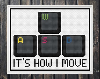 May include: A white framed cross-stitch design featuring a keyboard with the keys W, A, S, and D highlighted in different colors. The text "IT'S HOW I MOVE" is below the keys.