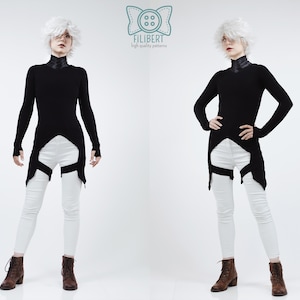 May include: A long-sleeved black tunic with a high collar and a pointed hemline, paired with white skinny trousers featuring black leg straps. The garment is displayed with a logo at the top center containing a button icon and the text FILIBERT.