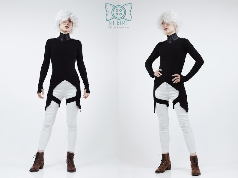 May include: A long-sleeved black tunic with a high collar and a pointed hemline, paired with white skinny trousers featuring black leg straps. The garment is displayed with a logo at the top center containing a button icon and the text FILIBERT.