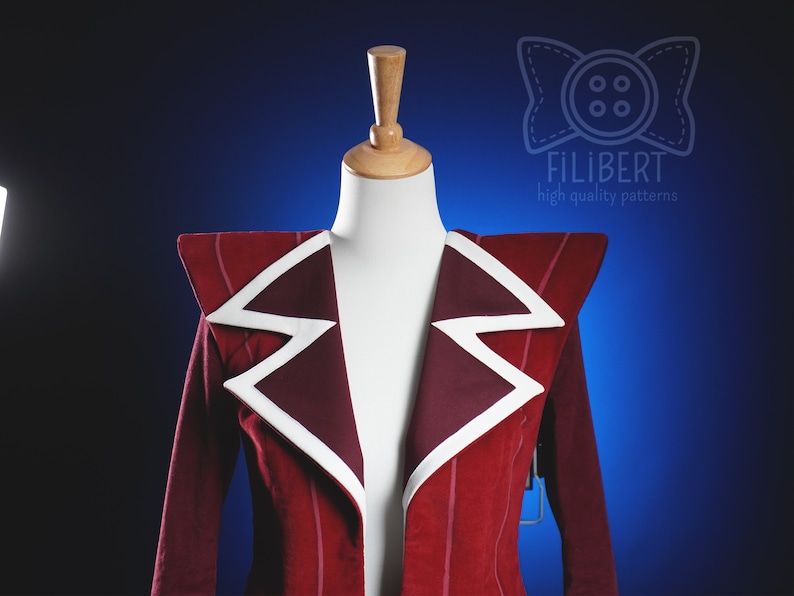 May include: A red blazer with white piping on the collar and shoulders. The blazer has a pointed collar and a single button closure. The blazer is on a white mannequin against a blue background.