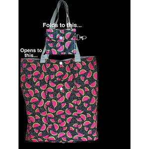 May include: A black tote bag and matching pouch, both adorned with a vibrant watermelon slice pattern. The tote bag folds into the smaller pouch for compact storage. The design features pink watermelon slices on a black background with white polka dots.