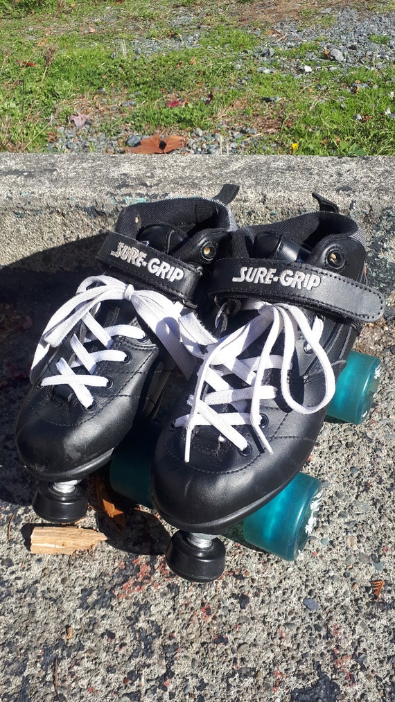 Rebel black quad roller skates