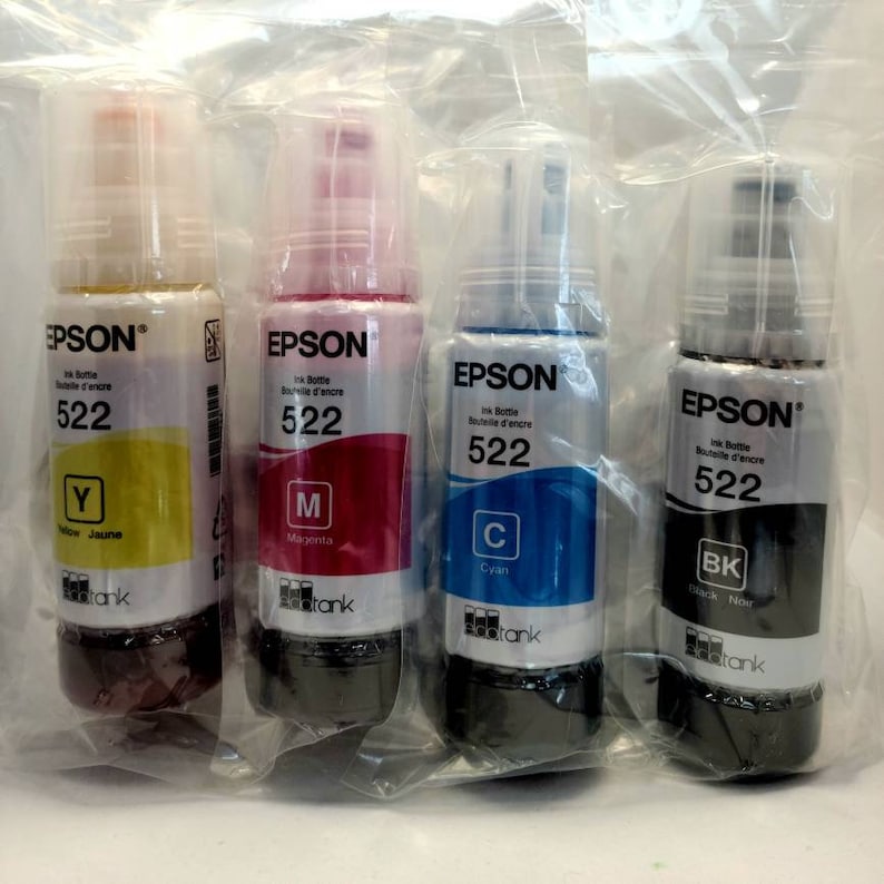 May include: Four Epson ink bottles, one each of yellow, magenta, cyan, and black. Each bottle is labeled with the Epson logo, the ink color, and the ink bottle number 522.