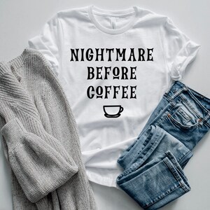 K&ouml;nnte beinhalten: Wei&szlig;es T-Shirt mit schwarzem Text, der "Nightmare Before Coffee" lautet, und einem kleinen Kaffeetassen-Symbol.