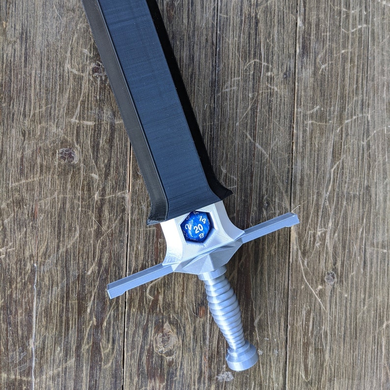 May include: A silver and black sword with a blue 20-sided die on the hilt.