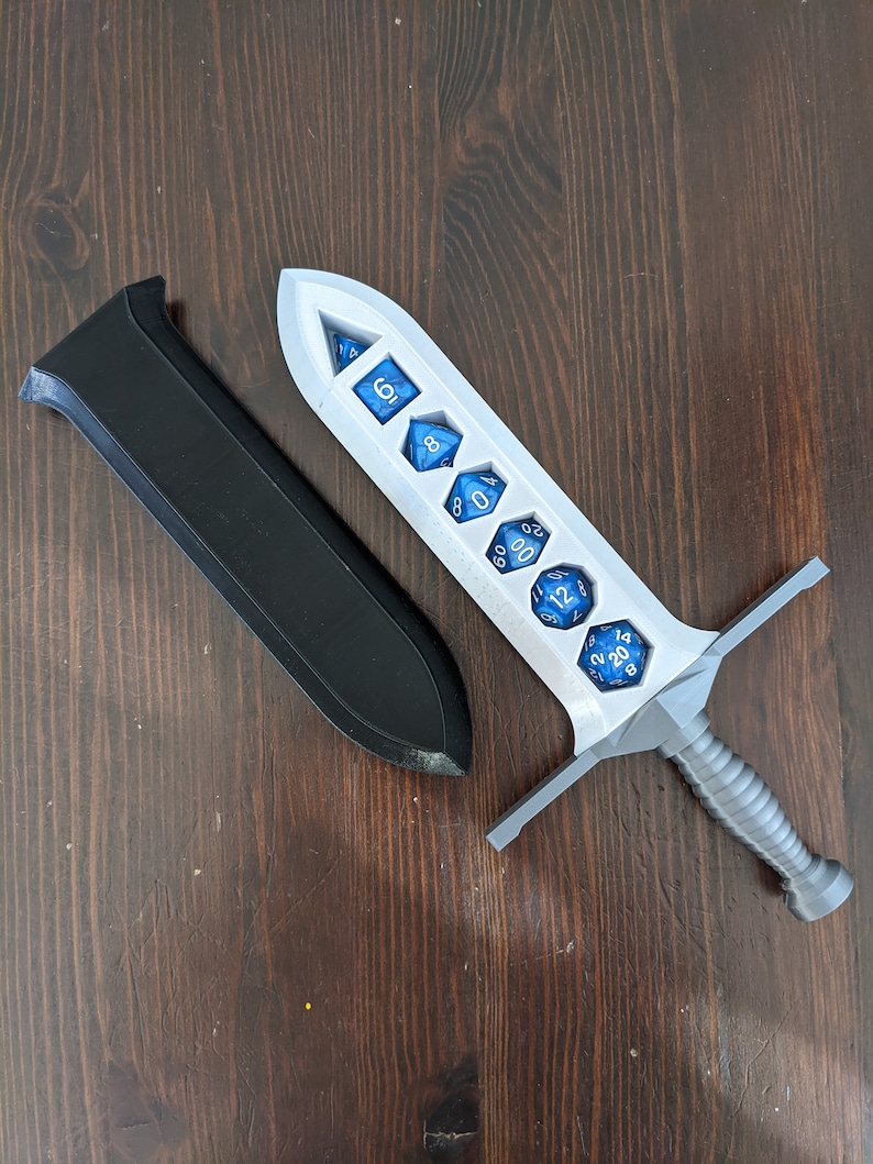 May include: A white plastic sword with a gray handle, designed to hold dice. The sword has seven slots for dice, each with a different number of sides. The dice are blue with white numbers.