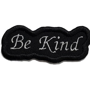 May include: Black embroidered patch with white stitching that reads "Be Kind".