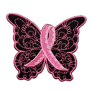 May include: Pink ribbon in the shape of a butterfly, embroidered on a black fabric patch.