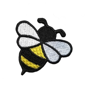 May include: A black and yellow embroidered bee patch with white wings.