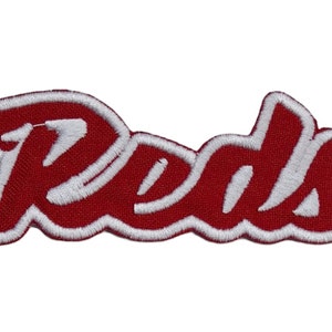May include: Red embroidered patch with the word "Reds" in a white outline.