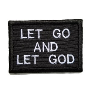 May include: Black fabric patch with white embroidered text that reads "Let Go And Let God".