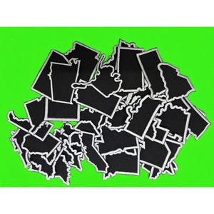 May include: A collection of black fabric patches shaped like various United States maps, each featuring a distinct white embroidered border. The patches are layered in a dense pile, showcasing diverse geographic outlines of different states.