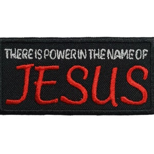 May include: Black embroidered patch with white text that reads "There is power in the name of" and red text that reads "JESUS".