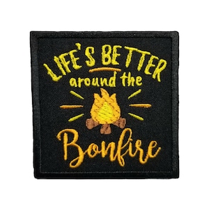 May include: Black embroidered patch with yellow stitching. The patch says "Life's Better around the Bonfire" with a stylized image of a campfire in the center.