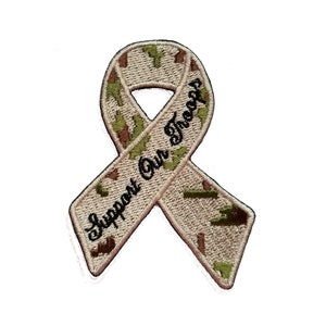Pode incluir: Uma fita de camuflagem bege e verde com o texto "Support Our Troops" bordado nela.