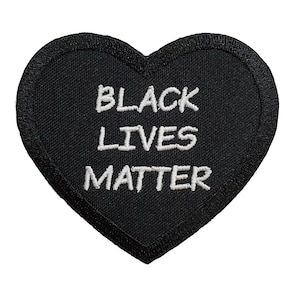 May include: Black heart-shaped patch with white embroidered text that reads "Black Lives Matter".