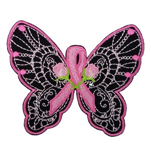 May include: Pink ribbon tied in a bow with two pink roses on a black butterfly with white lace design.