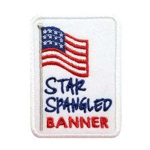 May include: Embroidered patch featuring the American flag with red and white stripes and blue stars. The text "STAR SPANGLED BANNER" is written below the flag in blue and red. The patch has a white border.
