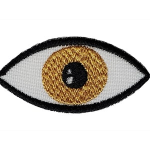 May include: A white eye patch with a black outline and a gold embroidered eye.